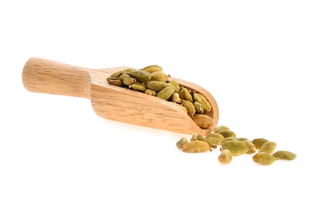 Green cardamom in a wooden scoop