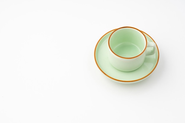 A green ceramic tea cup isolated on white background