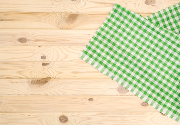 Green checkered tablecloth on wooden table