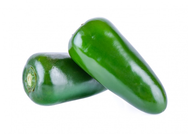 Green chili pepper on a white wall