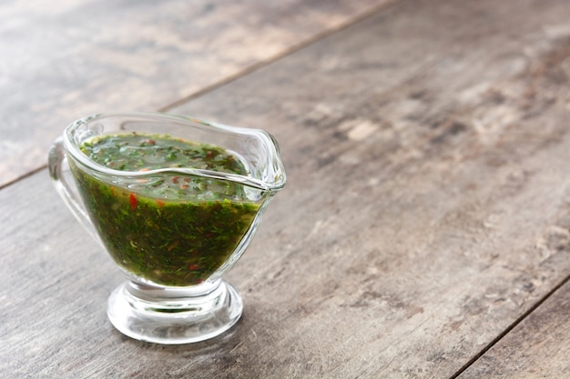 Green Chimichurri Sauce on wooden table copy space