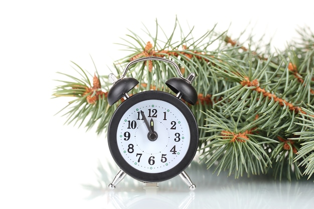 Green Christmas tree and clock isolated on white