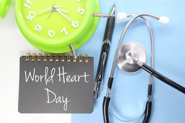 A green clock with a note that says world heart day on it.