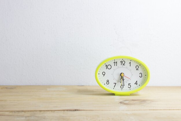 green clock on wood 