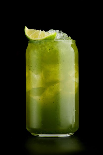 Green cocktail or lemonade with lime on black background closeup. Green Gin cocktail isolated