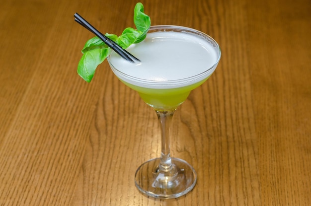 green cocktail with mint on the table