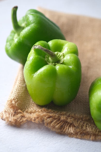 Green color capsicum on wooden background