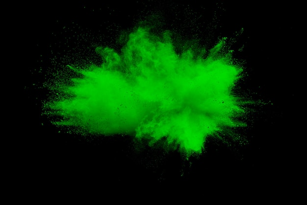 Green color powder explosion on black background.