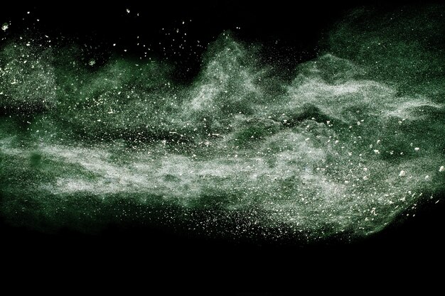 green color powder explosion on black background.