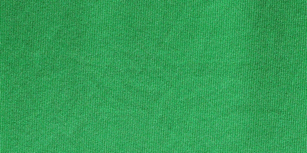 緑の色のスポーツ衣料品ファブリック サッカー シャツ ジャージー テクスチャとテキスタイル バック グラウンド ワイド バナー