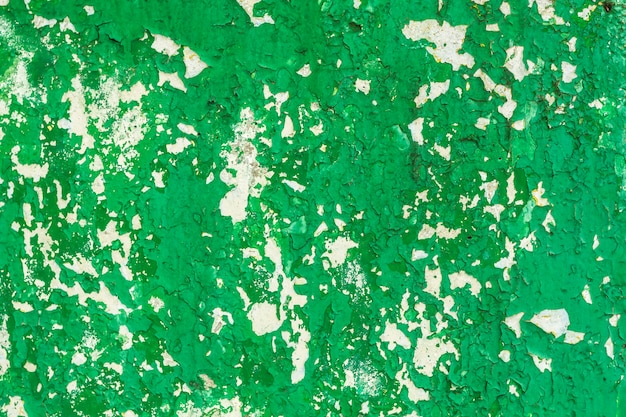 Green cracked paint on plaster.  