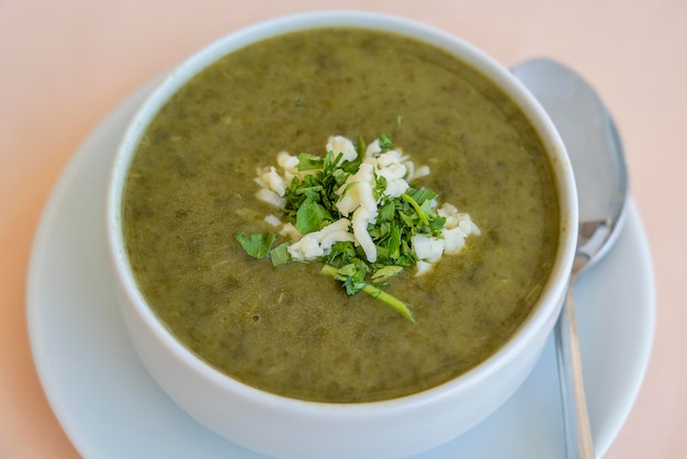 Green cream soup from spinach close up