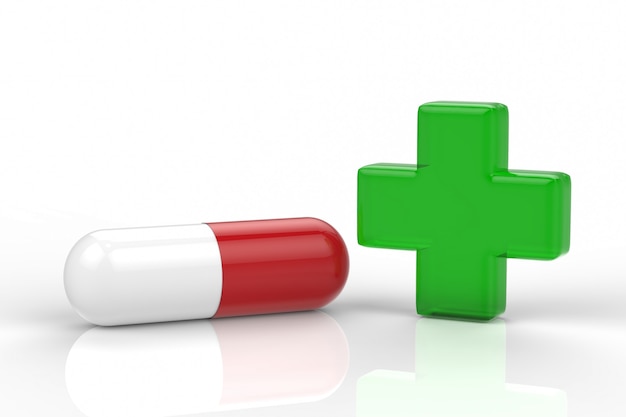 Green cross and capsule pill on white background