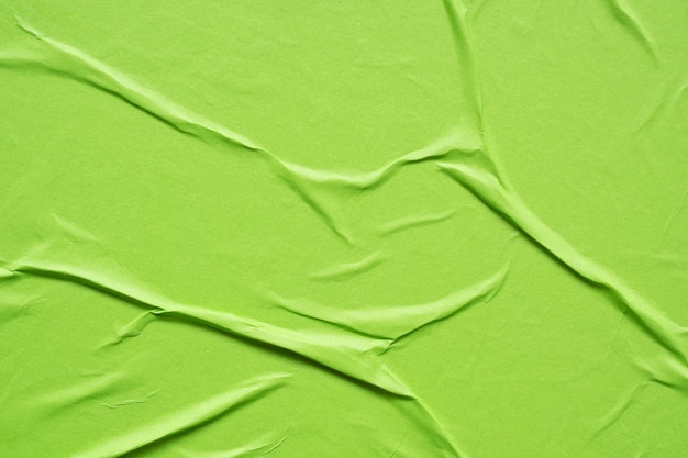 Green crumpled and creased paper poster texture background