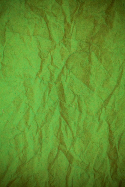 Green crumpled paper background.