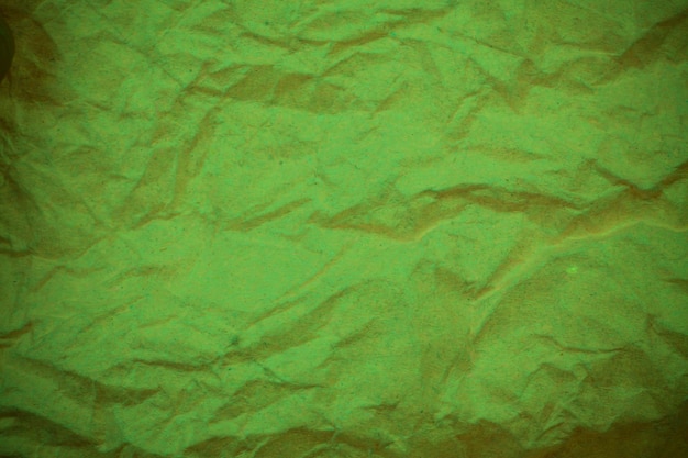 Green crumpled paper background.