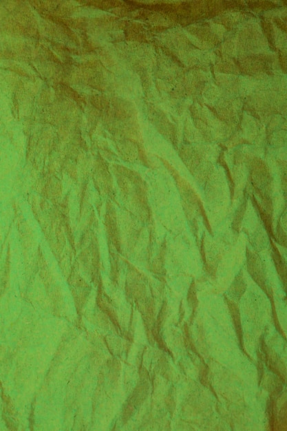 Green crumpled paper background.