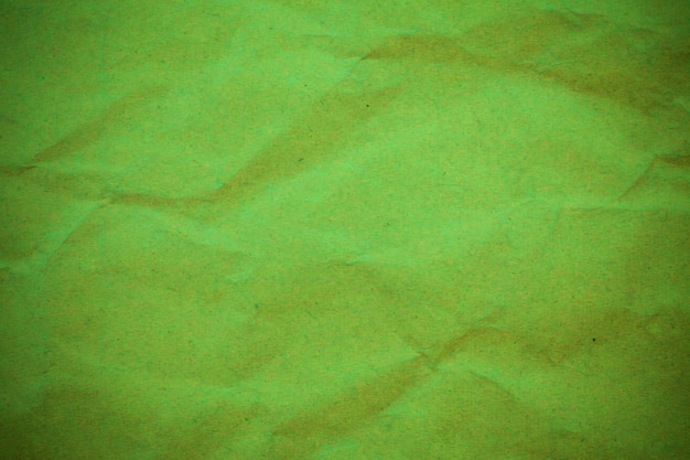 Green crumpled paper background.