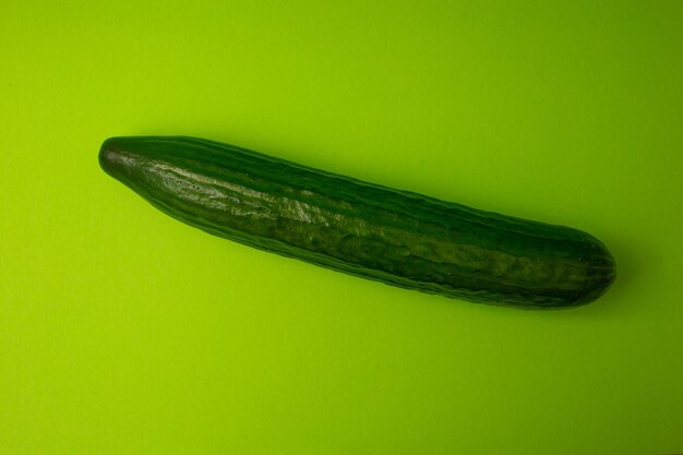 Green cucumber on a green background