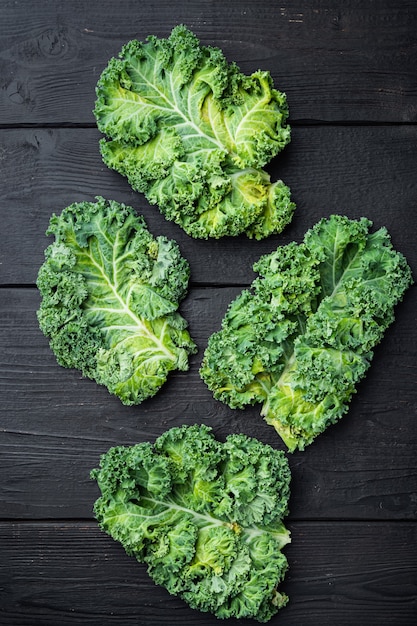 Green curly kale plant set, on black wooden table