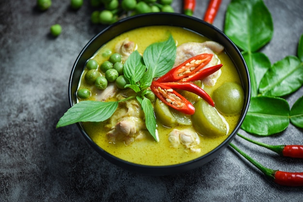 green curry chicken in a black bowl