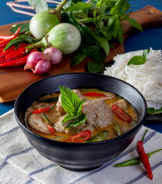 Green curry with fish ball on wooden background ,Thai cuisine