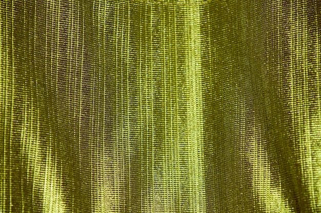 A green curtain with gold stripes.