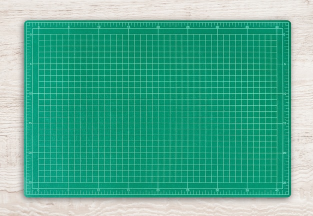 Premium Photo  Green cutting mat on wood texture background.