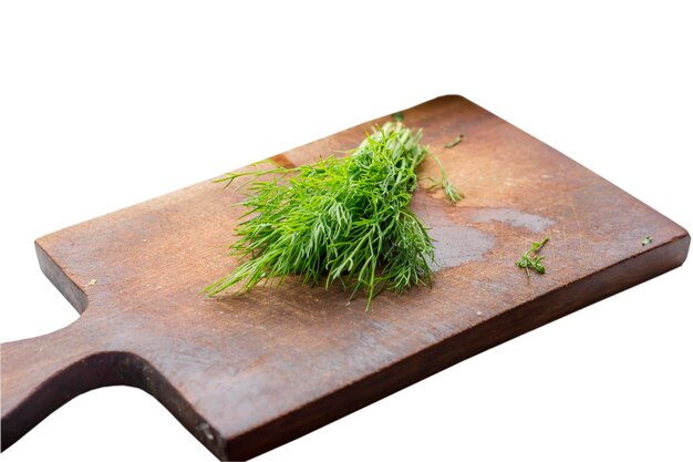 green dill on cutting desk isolated on white background