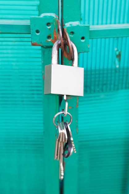 Photo green door locked with padlock