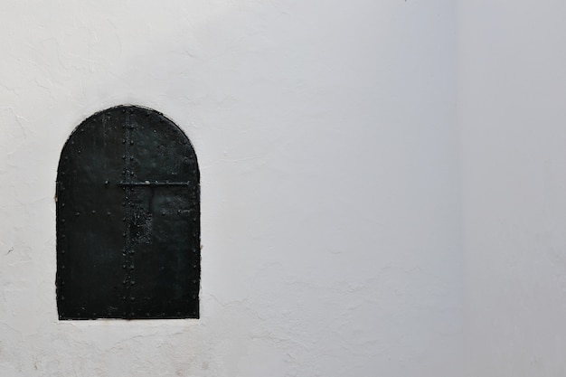 Green door on white wall background