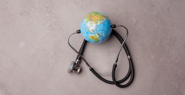 Green Earth day Save the wold and Global healthcare concept Stethoscope wrapped around globe