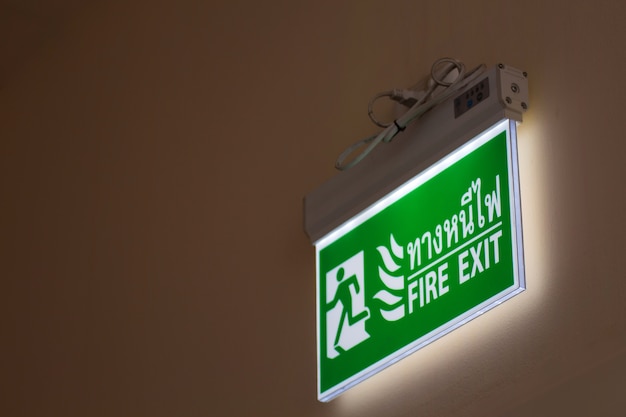 Green emergency exit sign in hospital showing the way to escape