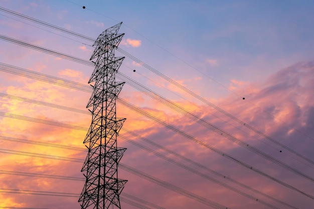 Green energy concept Electricity station Close up high voltage power lines at sunset electricity distribution station high voltage electric transmission pylon silhouetted tower