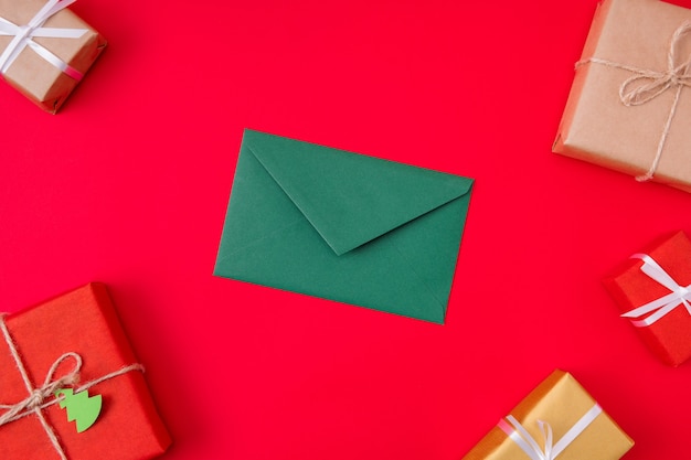 Green envelope lying among wrapped boxes