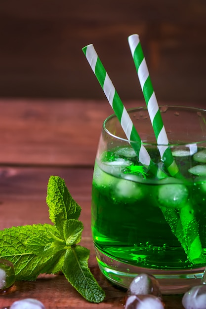 Green estragon drink with mint and ice cubes