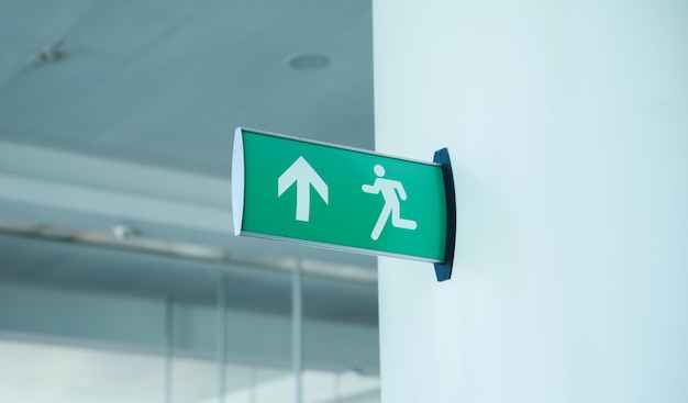 A green exit sign with the word fire on it