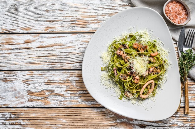 Green Fettuccine spinach pasta with seafood in cream sauce