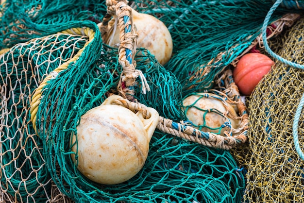 Green Fishing net with a buoys at the harbor. Close up