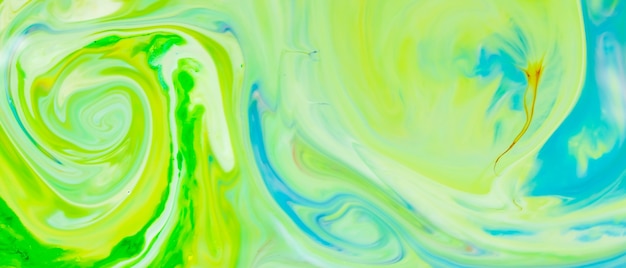 Green fluid art background. Liquid abstract pattern with UFO green. Marble texture of liquid surface. Fluid art