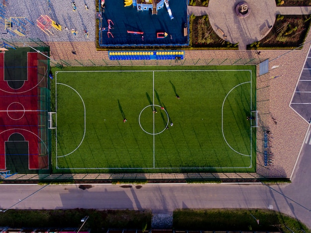 Green football stadium field. Aerial top view.