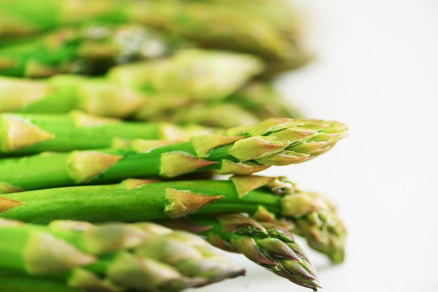 Green fresh asparagus on gray background. Top view. Raw, vegan, vegetarian and clean eating concept.