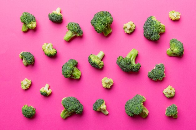 Green fresh broccoli background close up on colored table. Vegetables for diet and healthy eating. Organic food