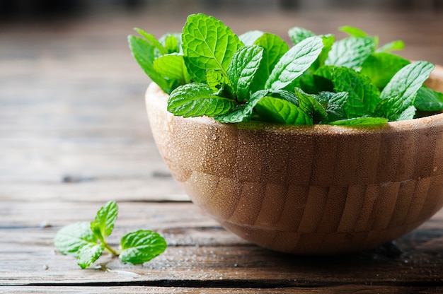 Green fresh mint om the wooden table