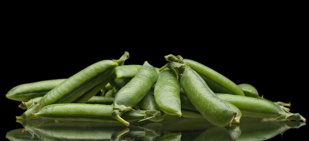 Green fresh peas isolated on black background