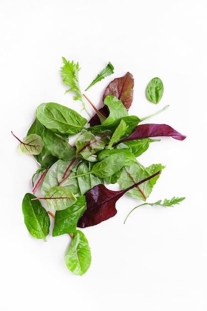 Green fresh salad leaves on white background. Isolated background. Food texture concept. Textspace. mixed salad