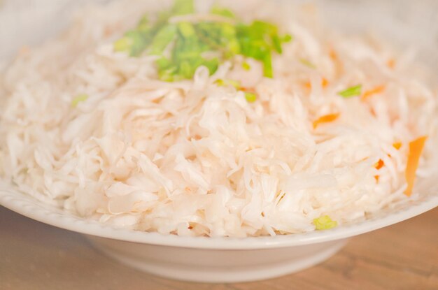 Green freshness cabbage and green onion shredded on wooden background