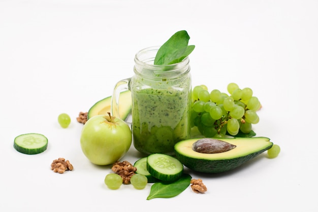 Green fruits and vegetables on a white surface