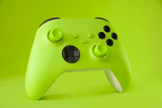 Green game controller on green background