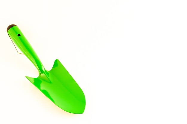 Green garden shovel isolated on white background with copy space